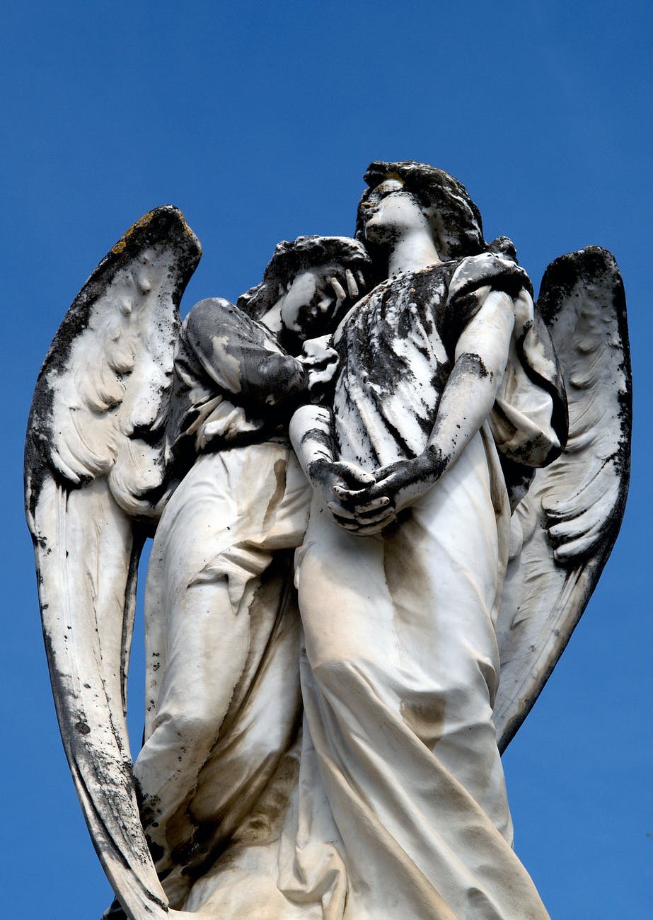 Two Angel Sculptures Hugging Each Other