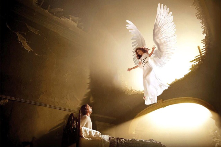 A Female Angel appearing in front of a man looking up at her