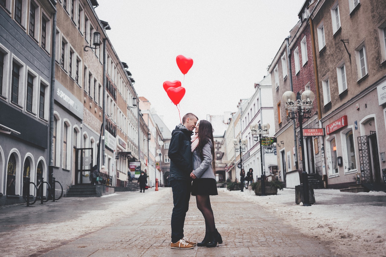 Couple kissing in the middle of City Street 