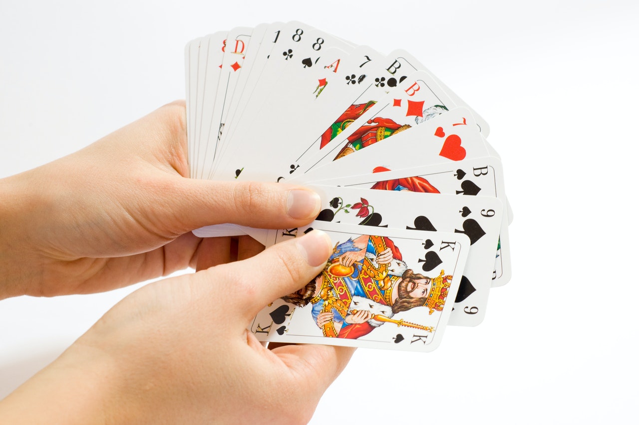 Person Holding Playing Cards