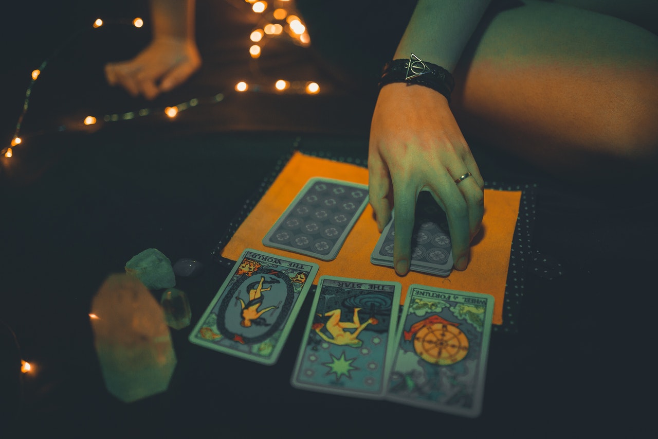 A female future teller with tarot cards on table