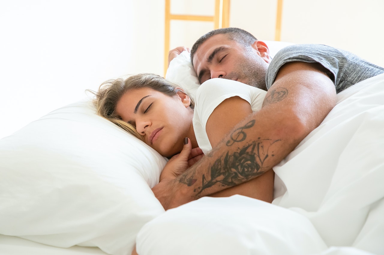 A Man Is Hugging a Woman While Sleeping