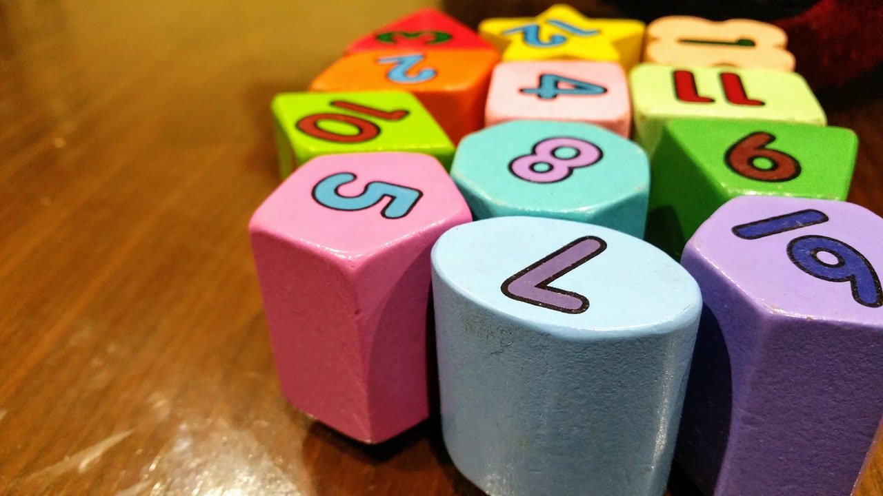 Assorted-color Dice Toy on Wooden Table
