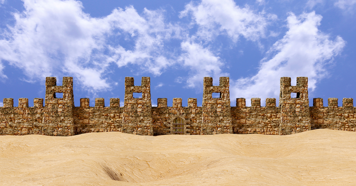 The Walls Of Jericho standing on sandy desert against a blue sky