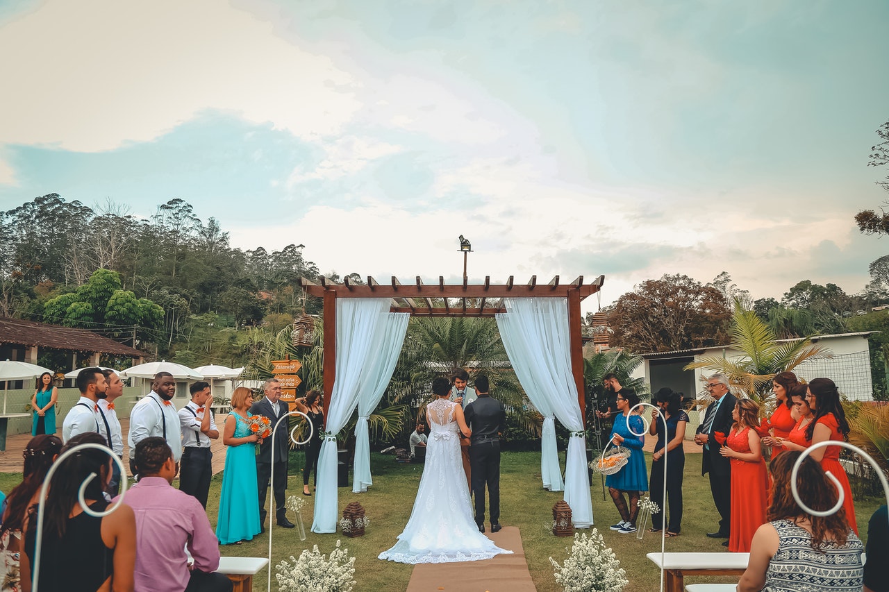 Outdoor Wedding with guests on either side of the bride & groom