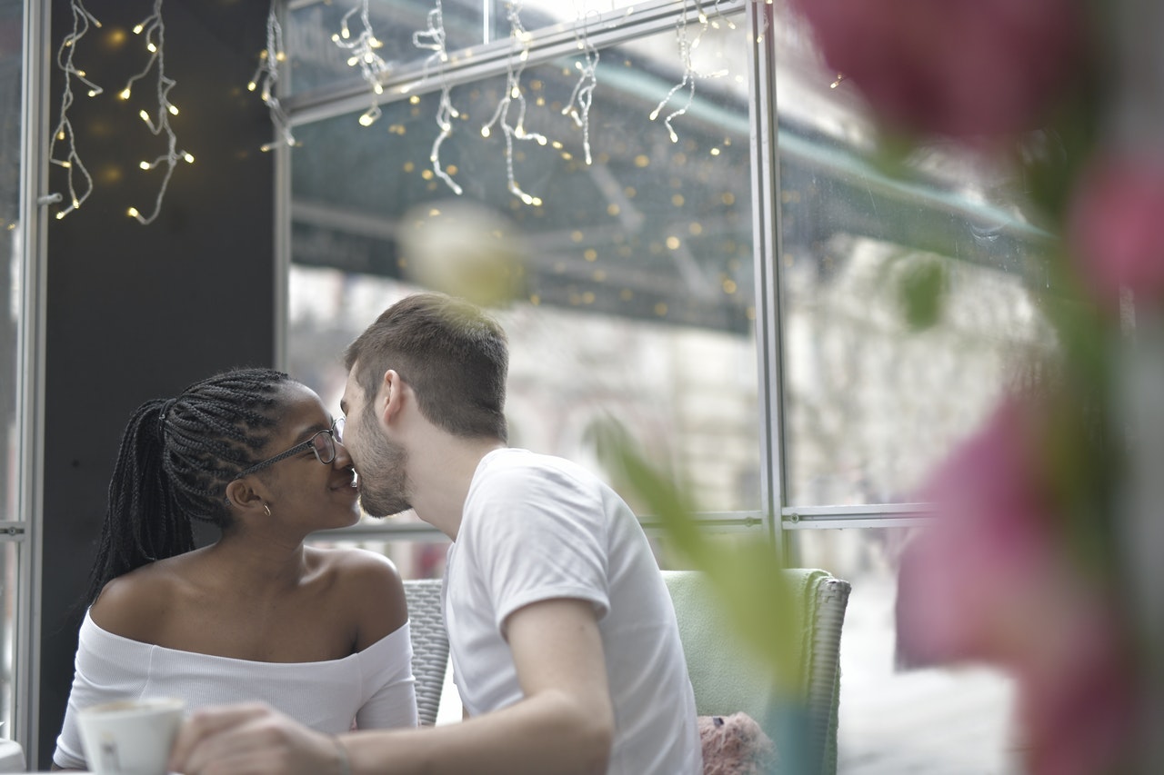 A Man Kissing a Woman in a restaurant