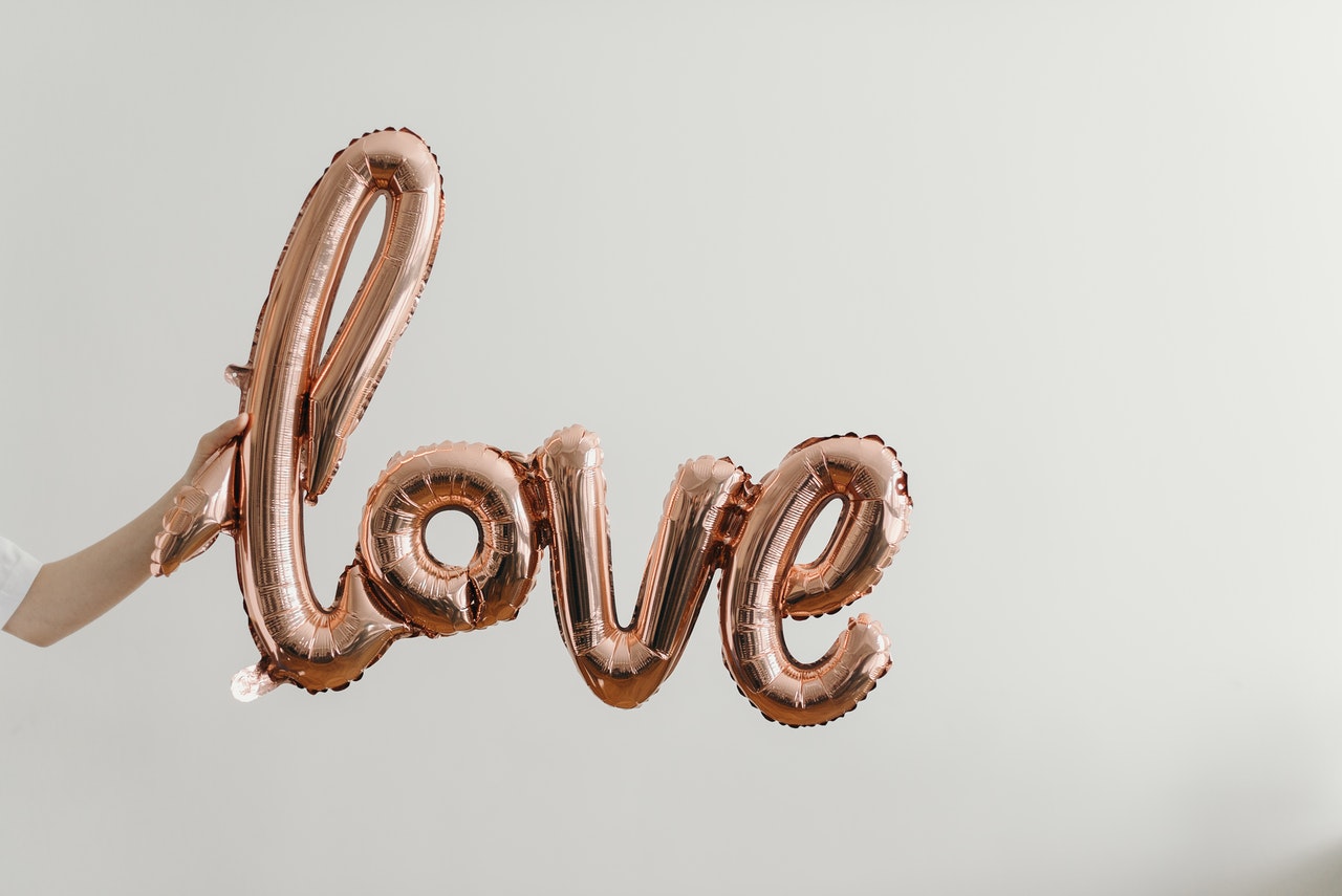 Love written on wall using brown steel letters