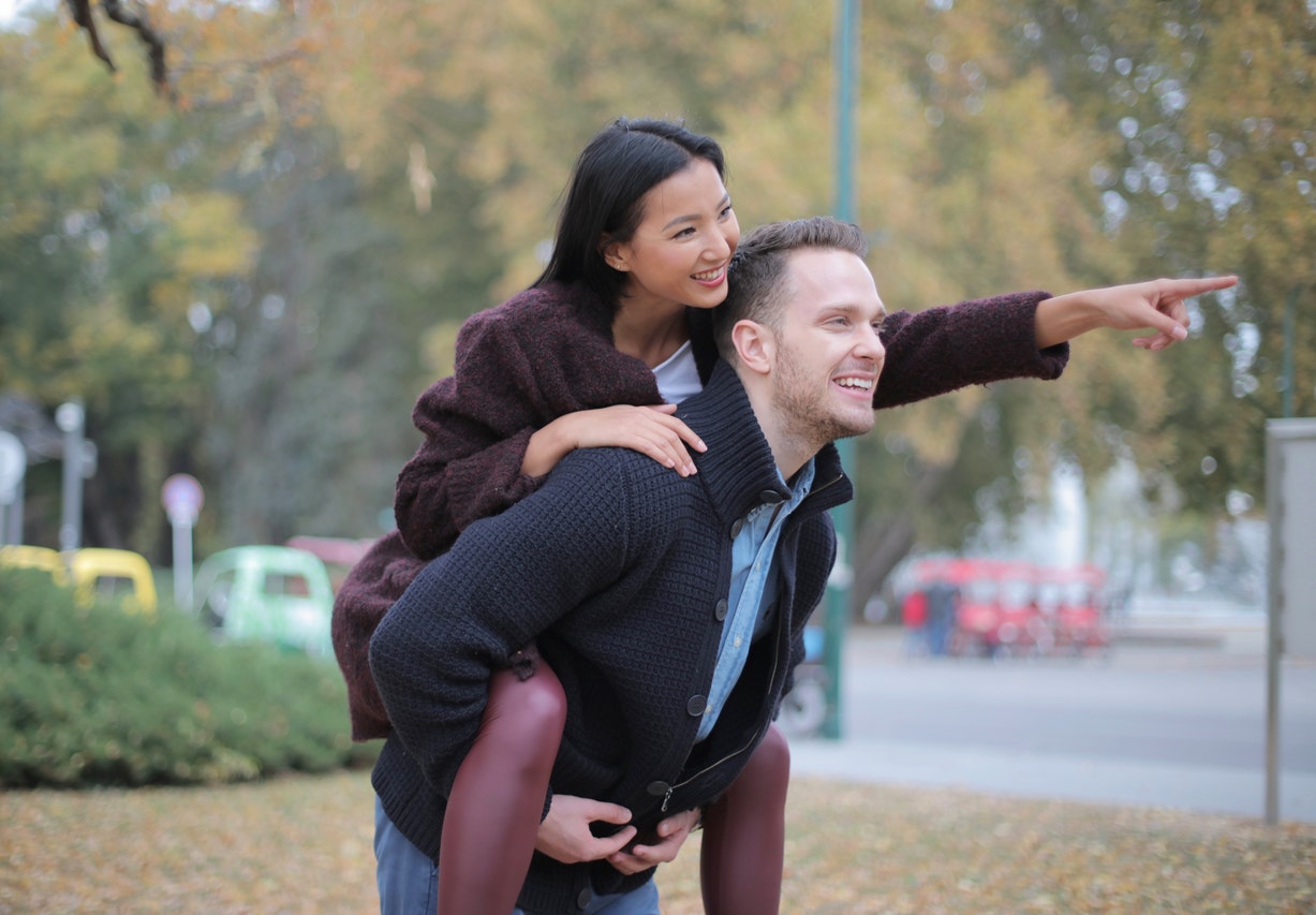 Man Giving Woman Piggyback Ride Marriage Compatibility