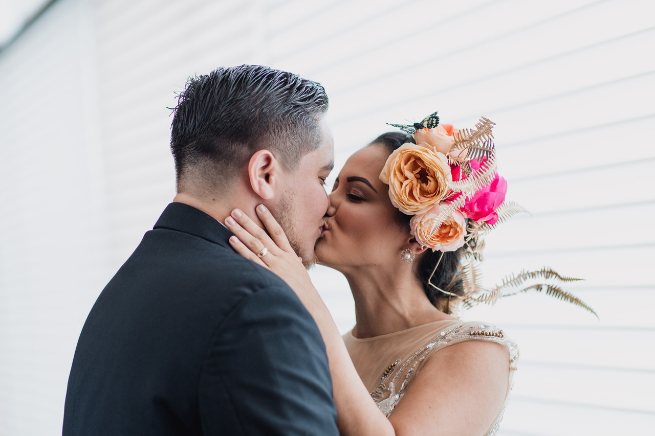 Bride with flowers on her head Kissing her groom
