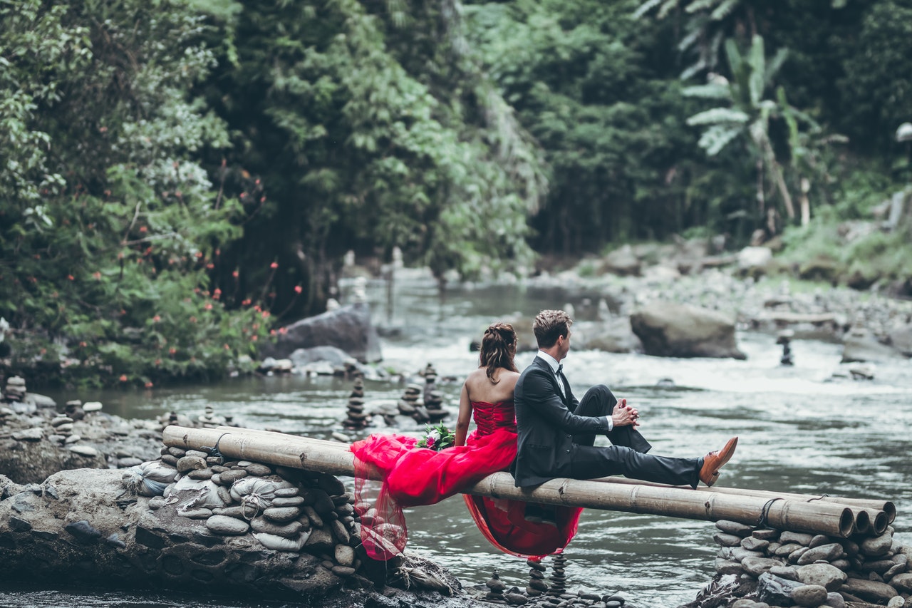 Man And Woman Sitting On Bamboos having their prenup photoshoot