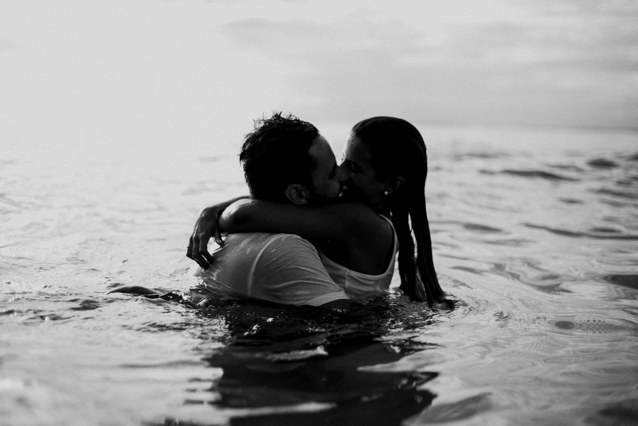 A Man And A Woman Kissing Together In The Sea