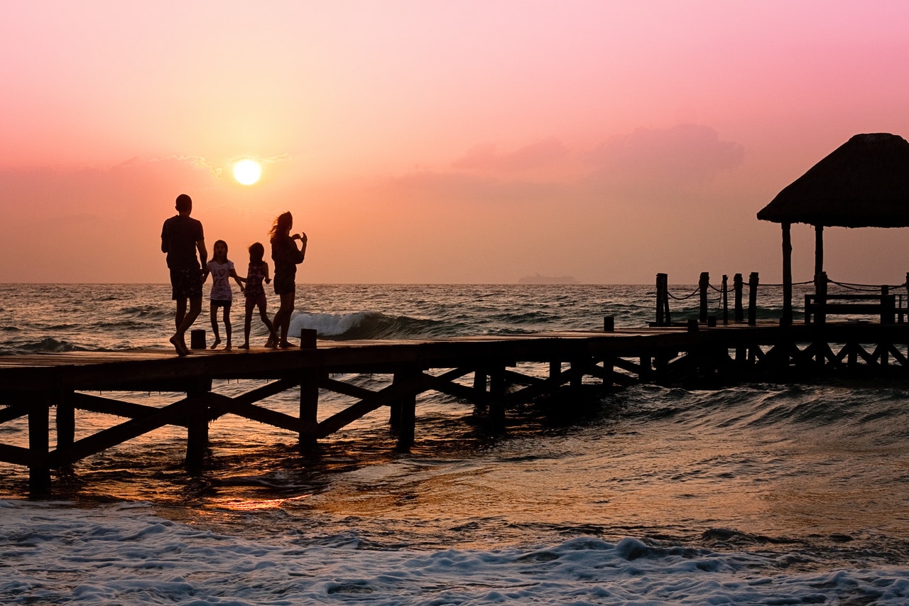 Family is Standing on Dock during Sunrise