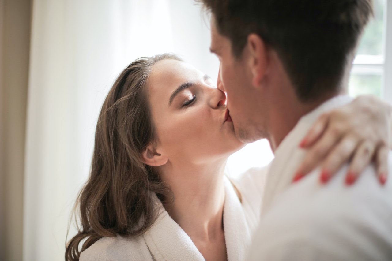 A Couple wearing bathrobes Kissing Each Other