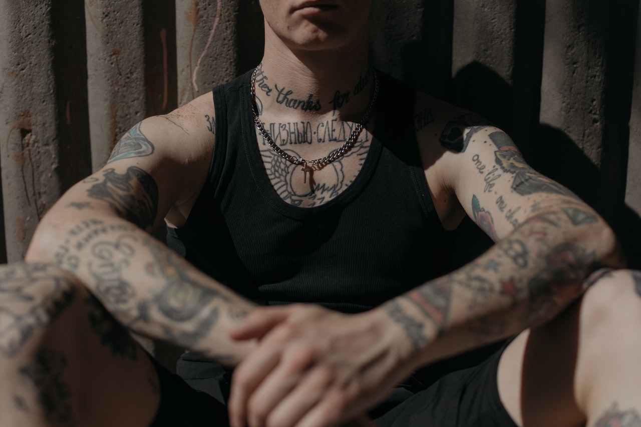 Man in Black Tank Top With Tattoo on Arm