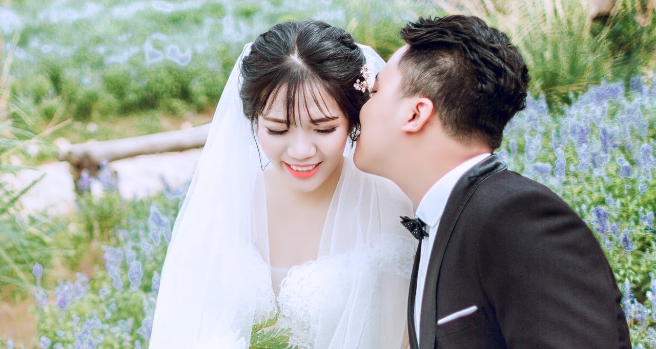 A Groom Kissing His Bride on Her Cheek