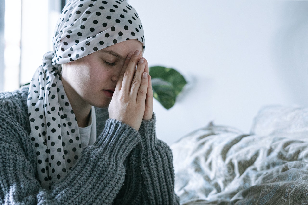 Woman in Gray Knit Sweater Covering Her Face With White and Black Polka Dot Hijab