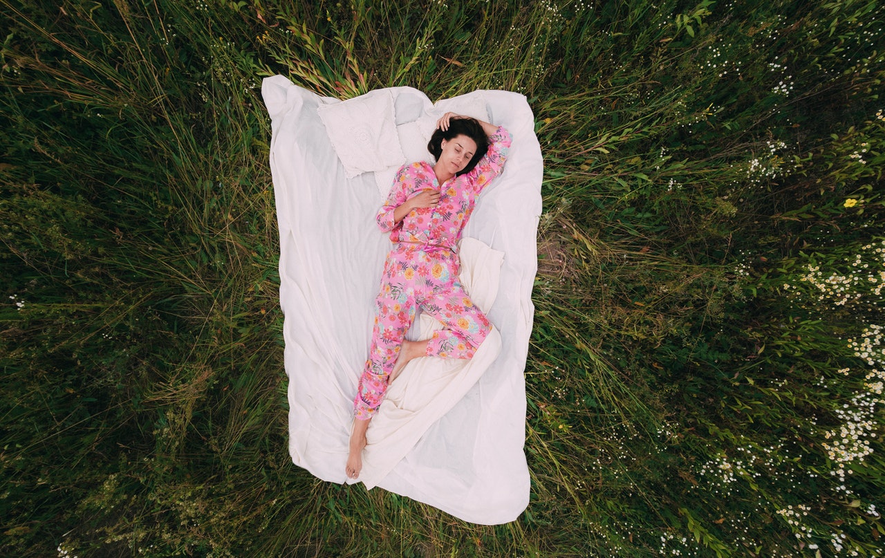 Woman in Pink Floral Pajama Lying on White Textile.jpg
