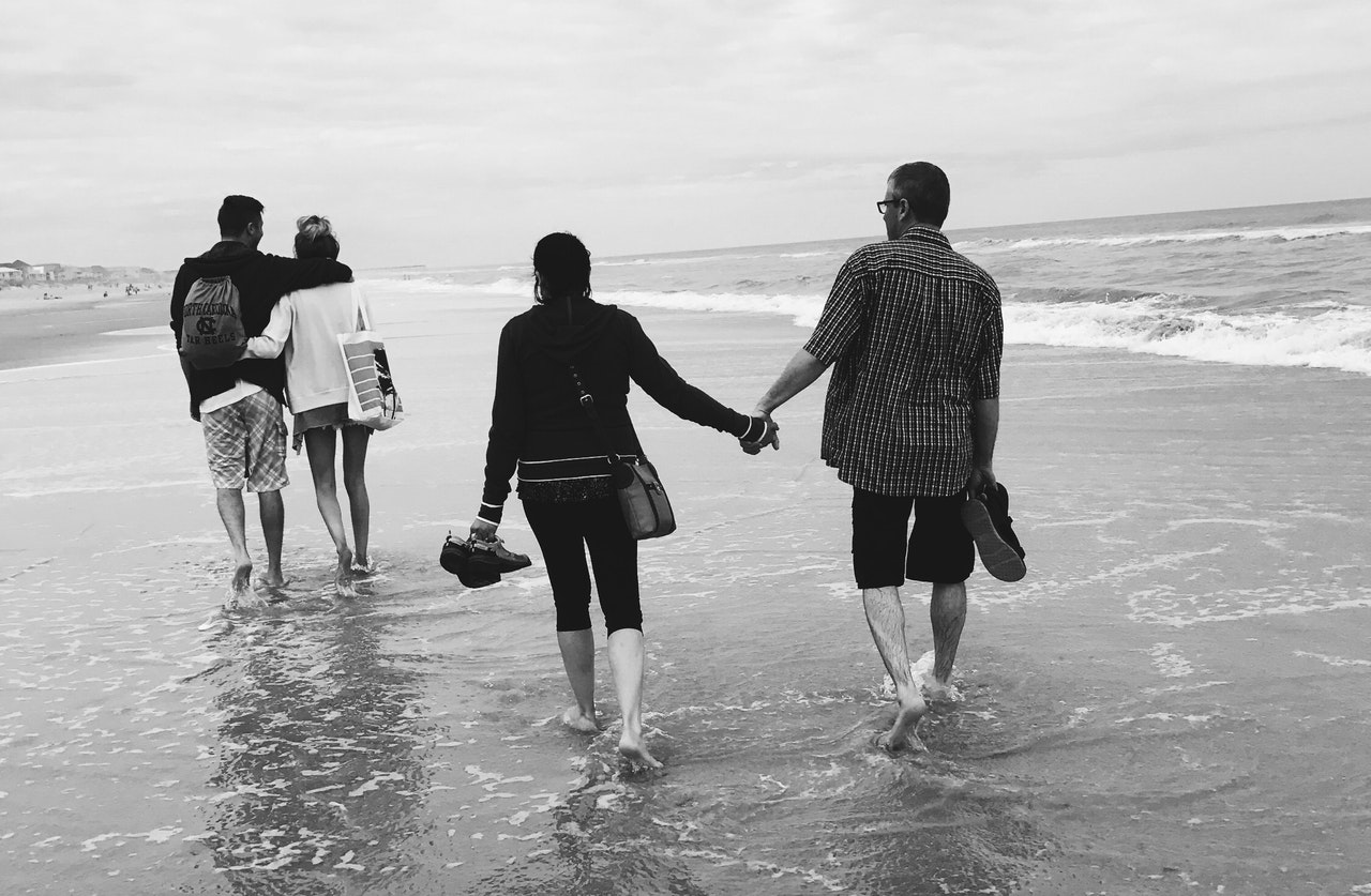 Two Couples Walking At the Beach