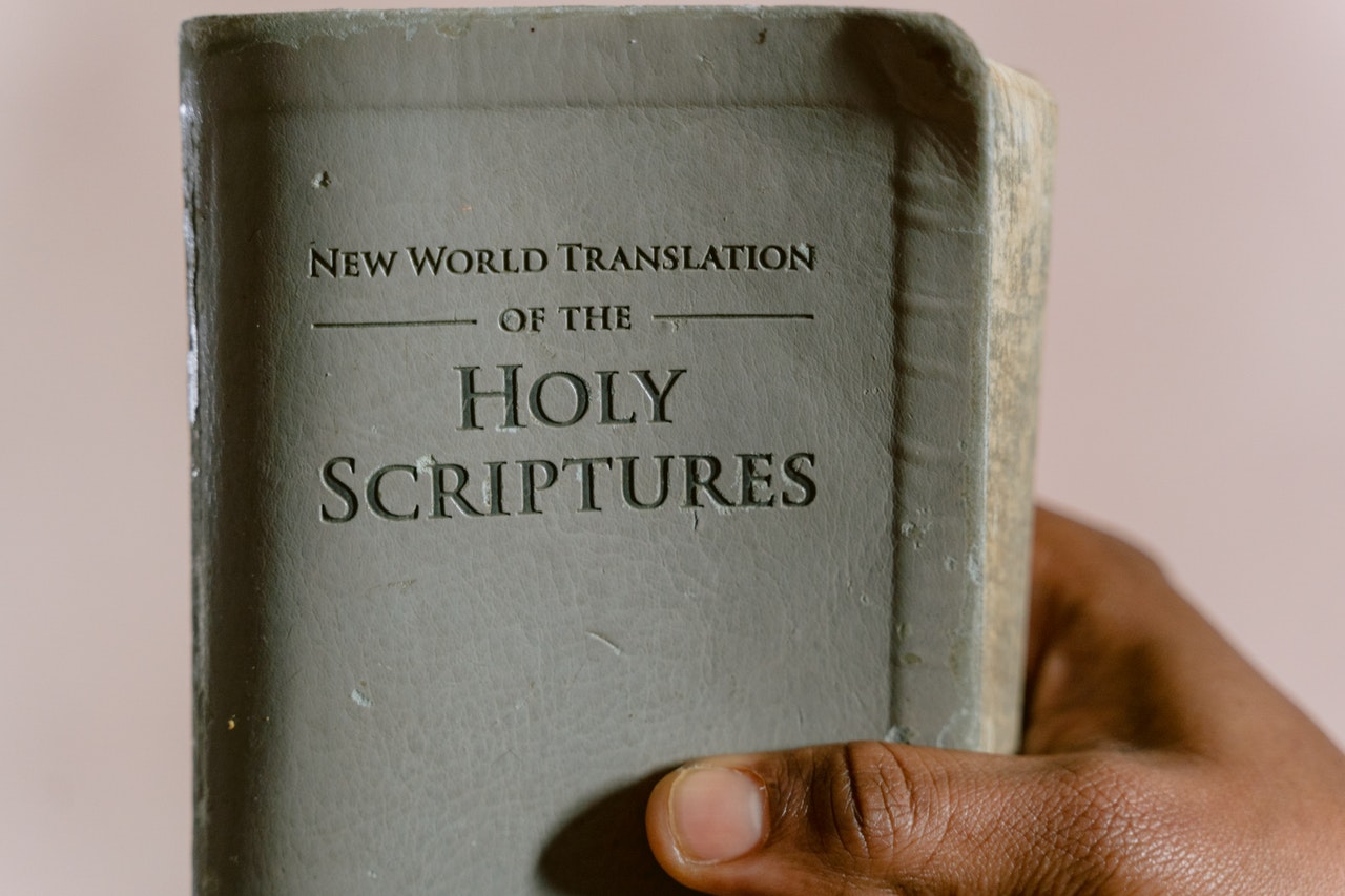 A Person Holding A Holy Bible
