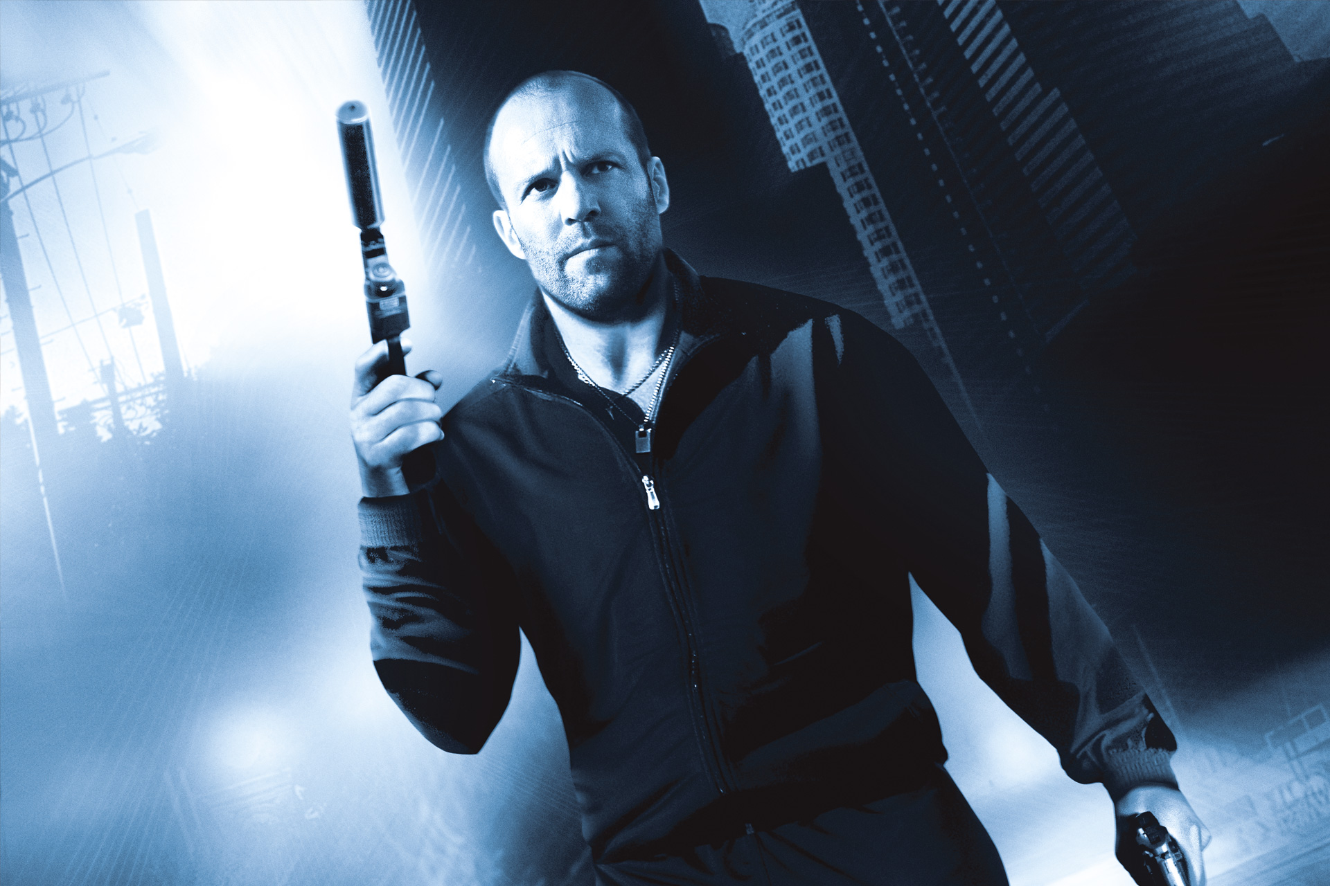 Jason Statham wearing black jacket while holding guns with both of his hands