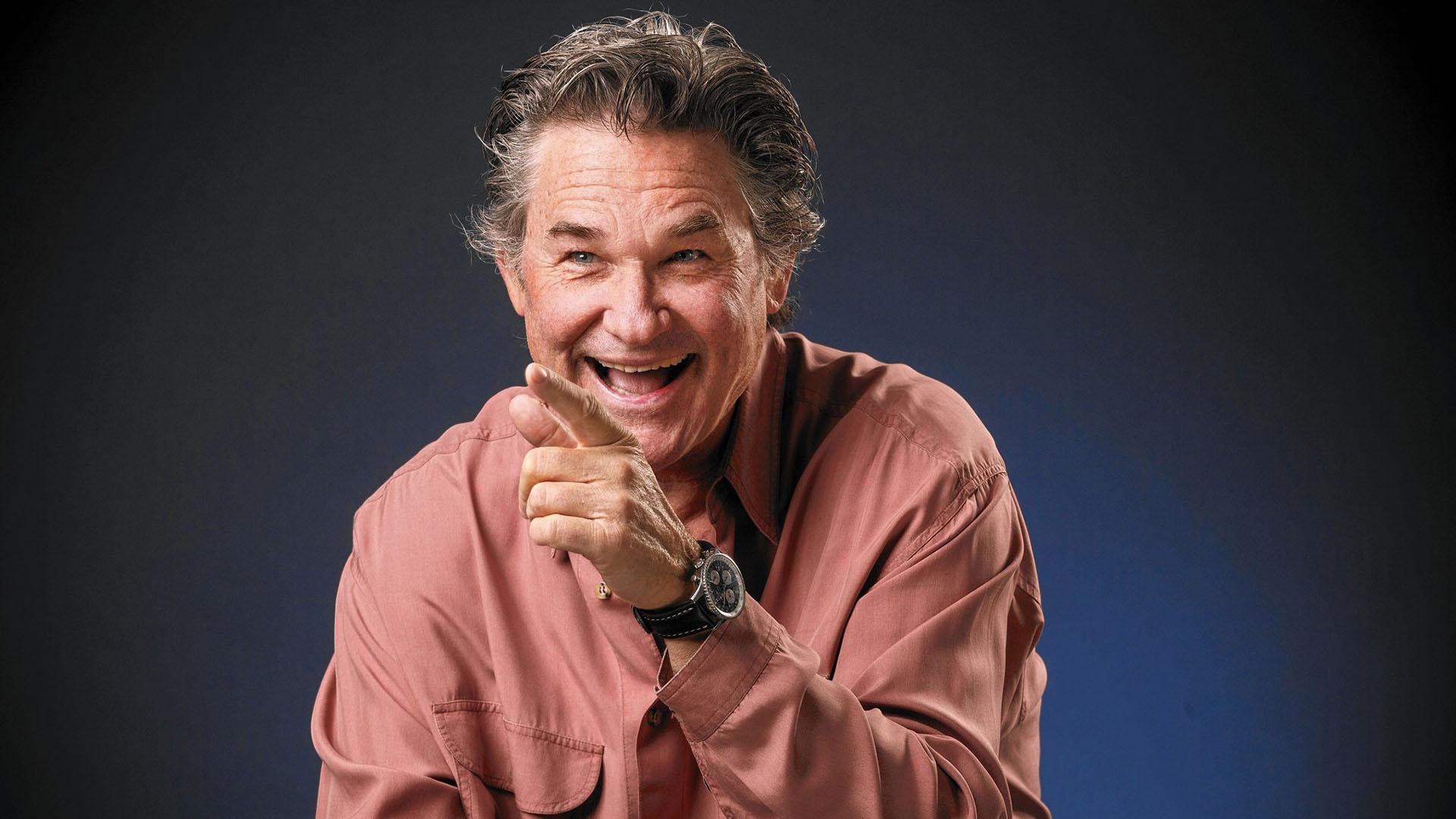 Kurt Russell laughing while pointing his finger