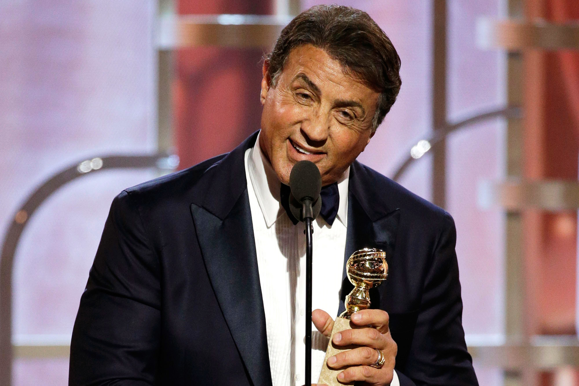 Sylvester Stallone receiving an award and making his speech on the stage