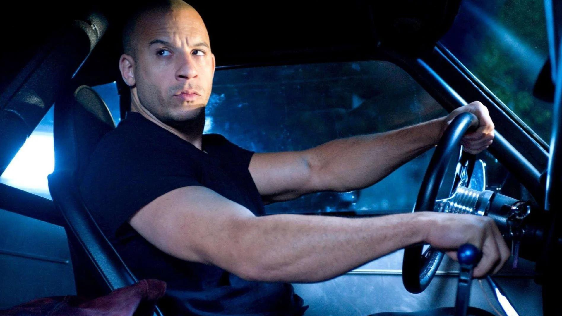 Vin diesel wearing black shirt while driving a car