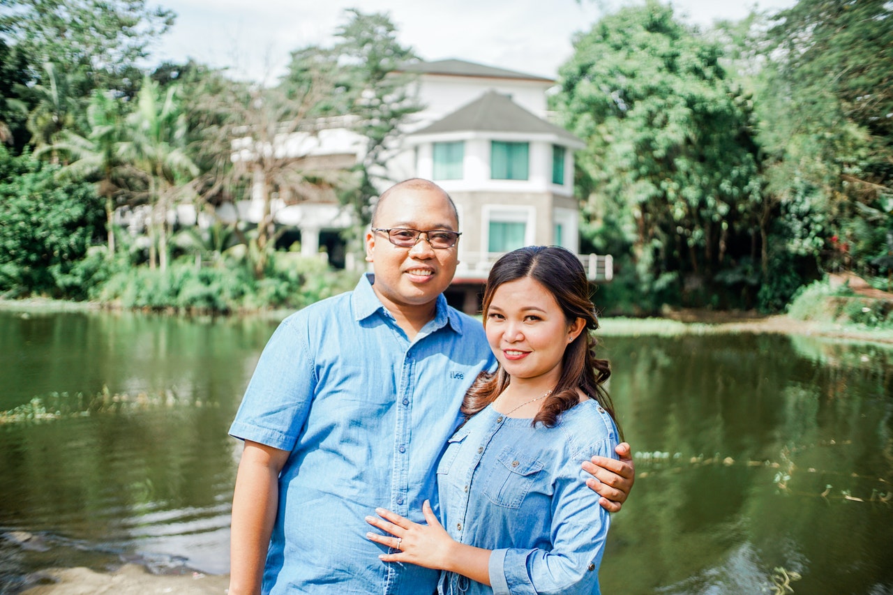 Couple Wearing Blue Button Up Shirt While Smiling