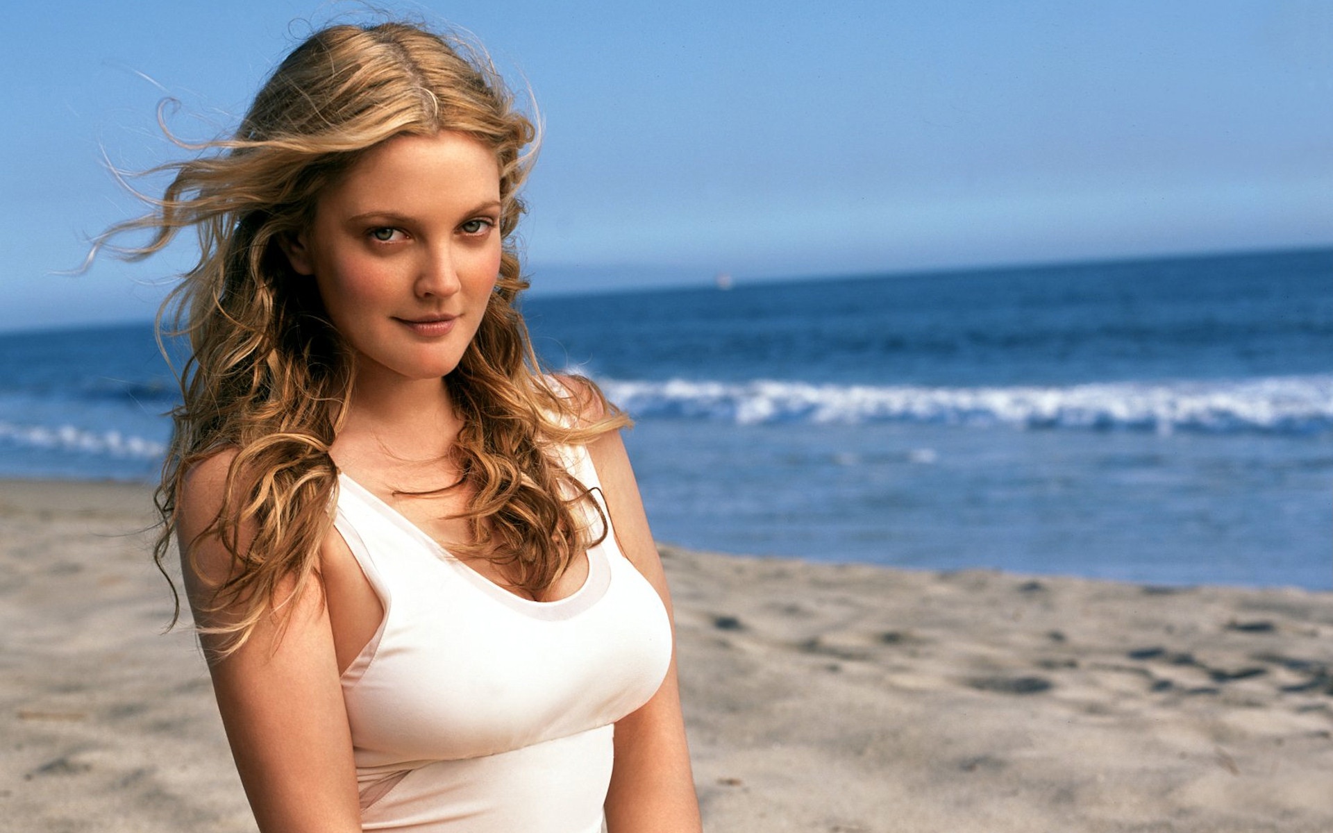 Drew Barrymore smiling while on the beach