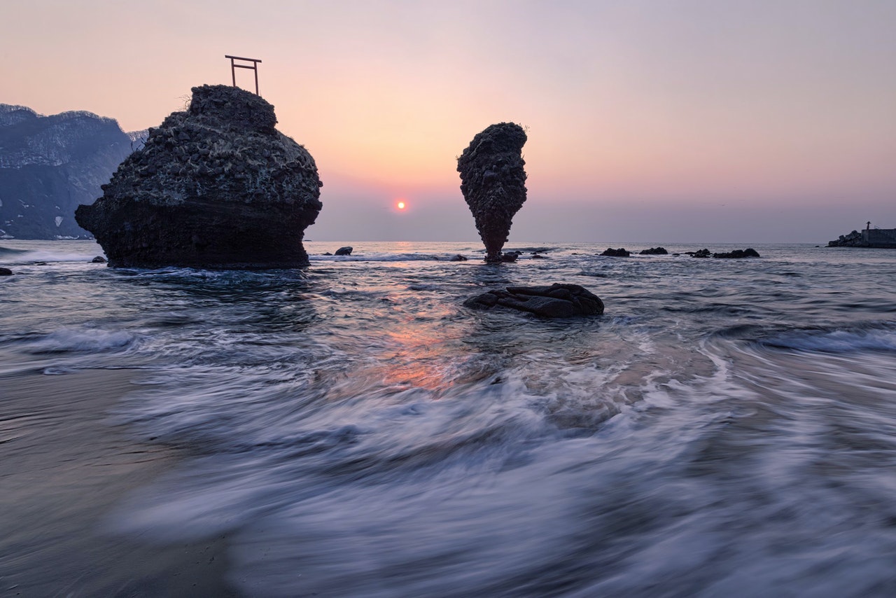 Rock Formations In The Sea During Sunset