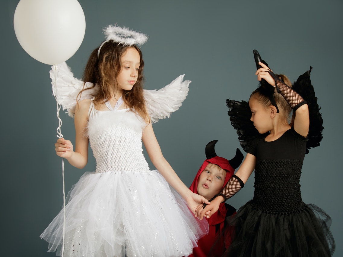 Three Children in Halloween Costumes