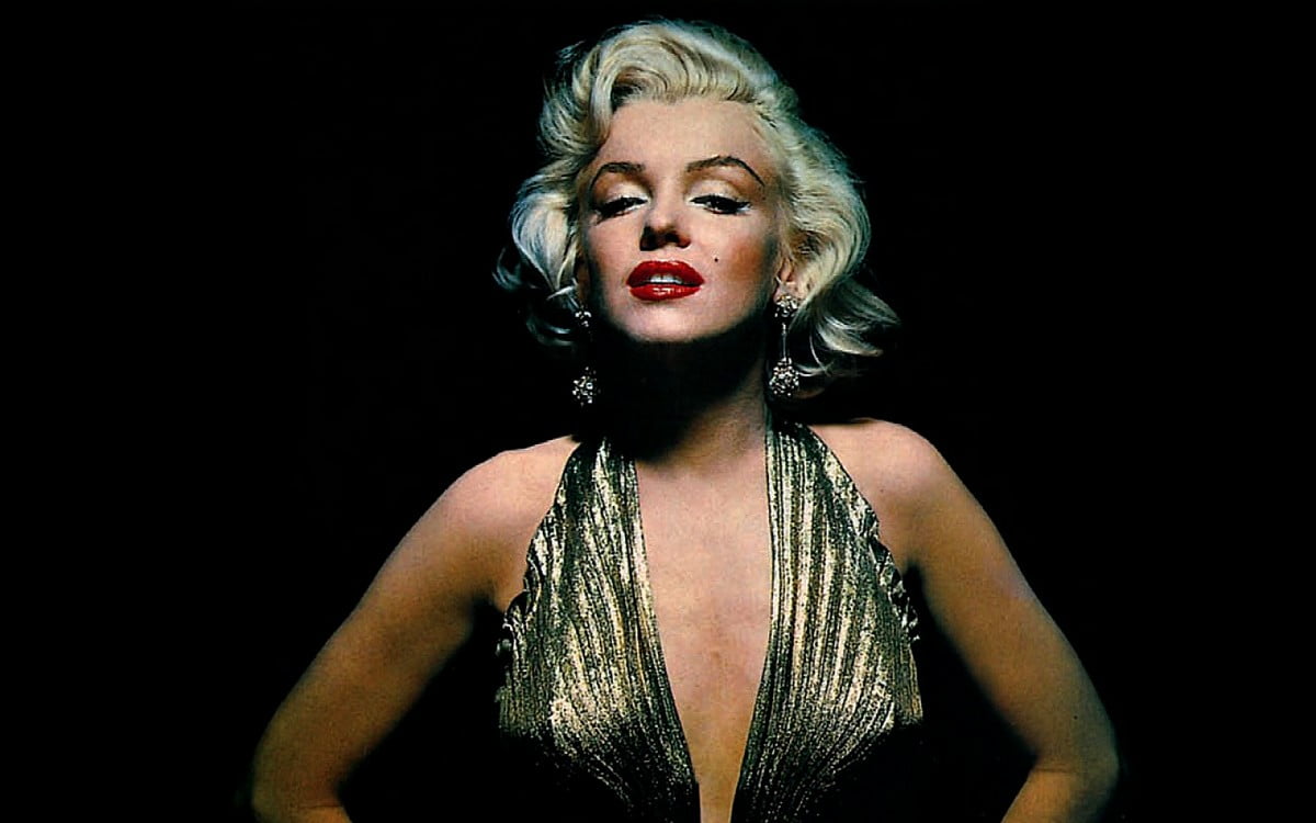 Marilyn Monroe wearing a sexy gold dress and red lipstick