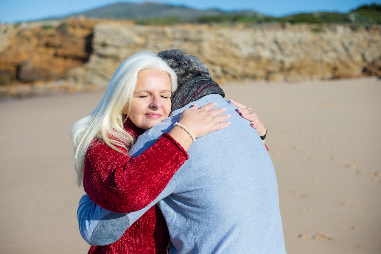 Blond Elderly Woman Hugging Man
