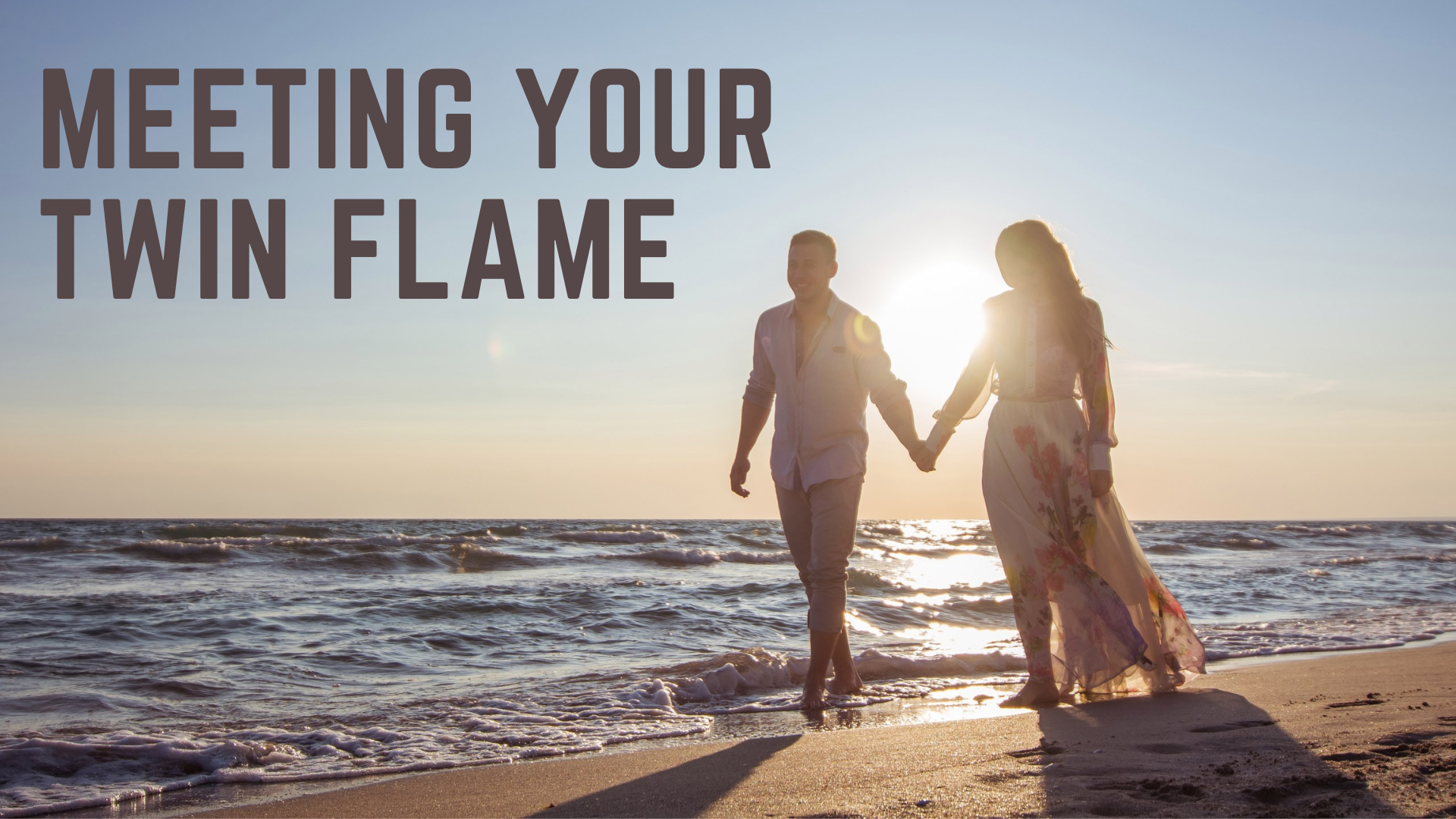 Couple walking at the beach while holding hands with words Meeting Your Twin Flame