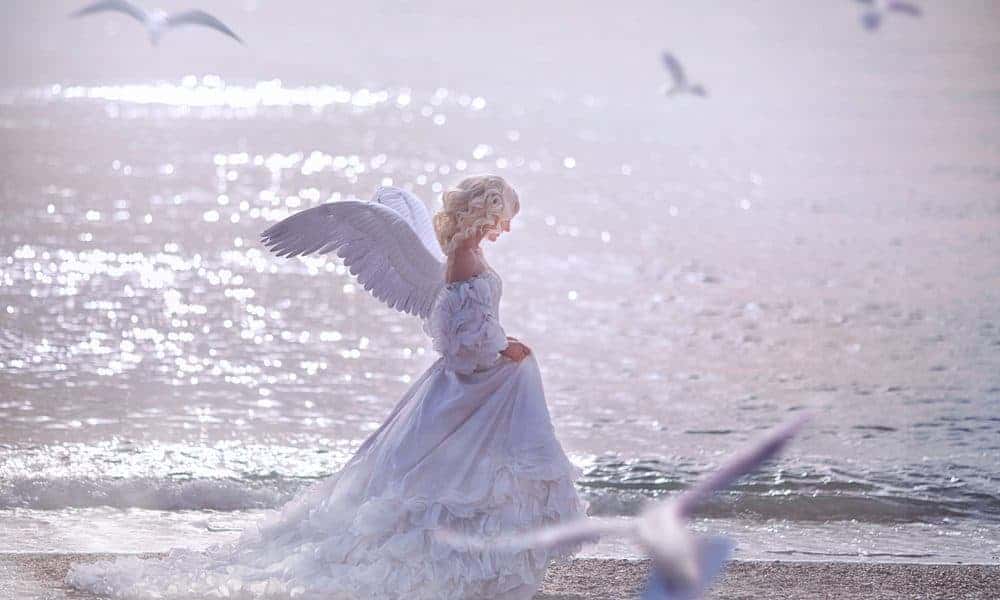 Girl In White Dress Walking On Sea Shore