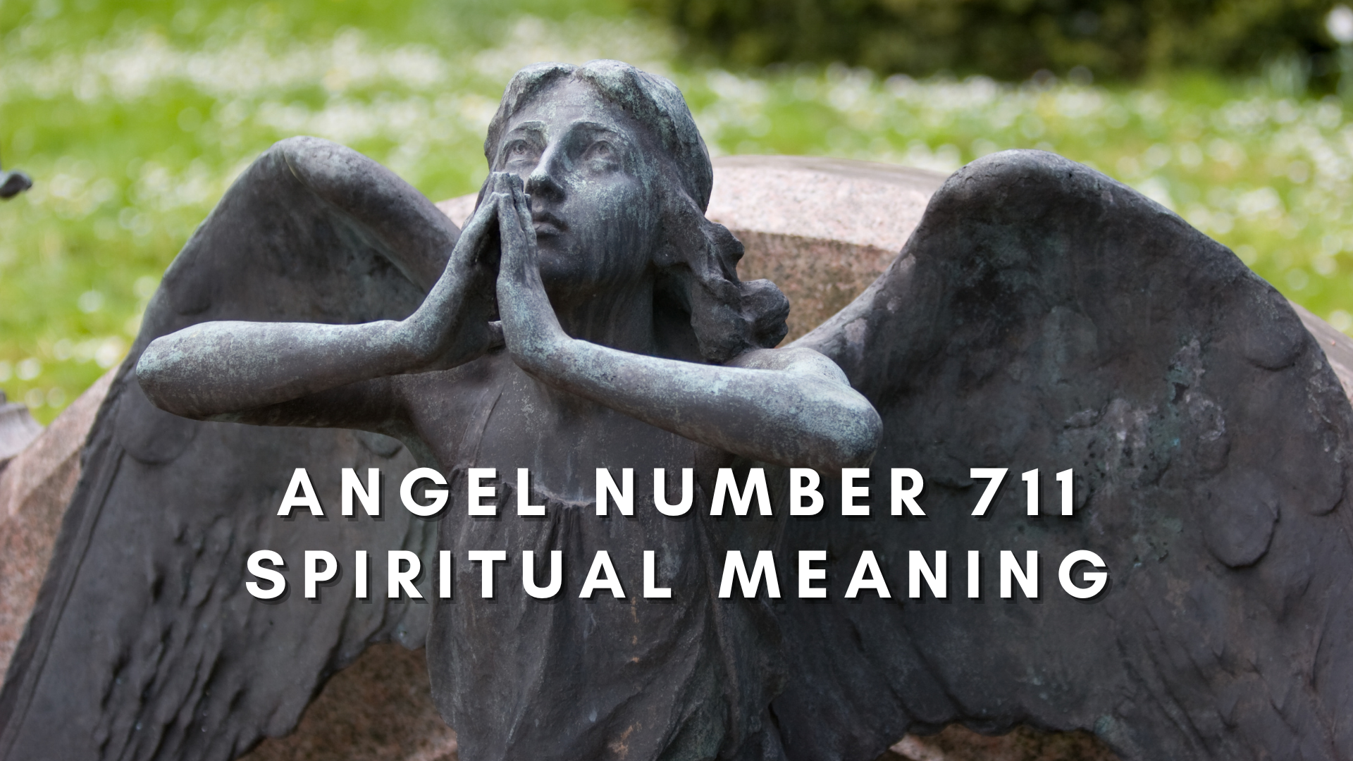 A praying angel statue with words Angel Number 711 Spiritual Meaning