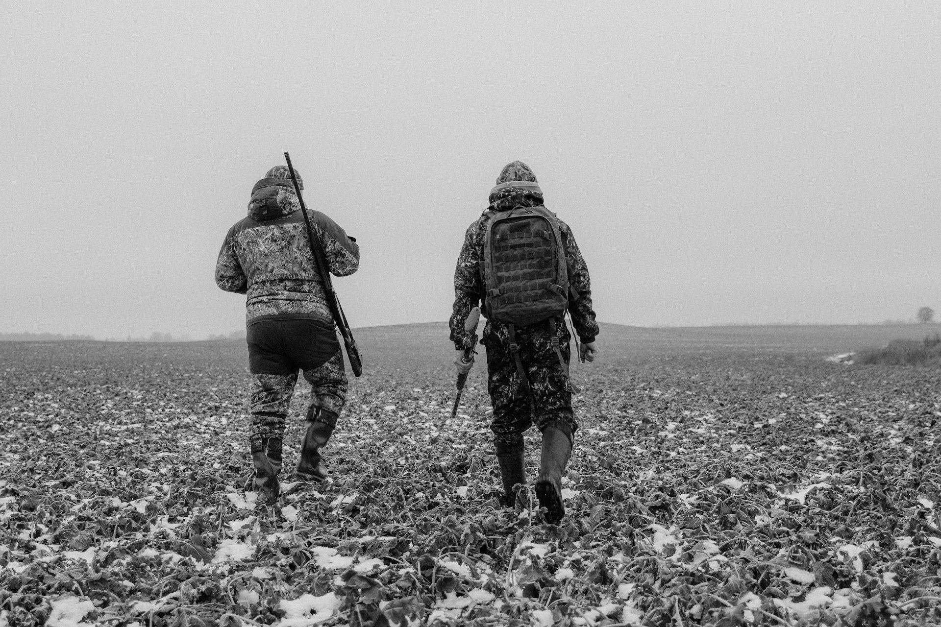Two Men Carrying Rifles