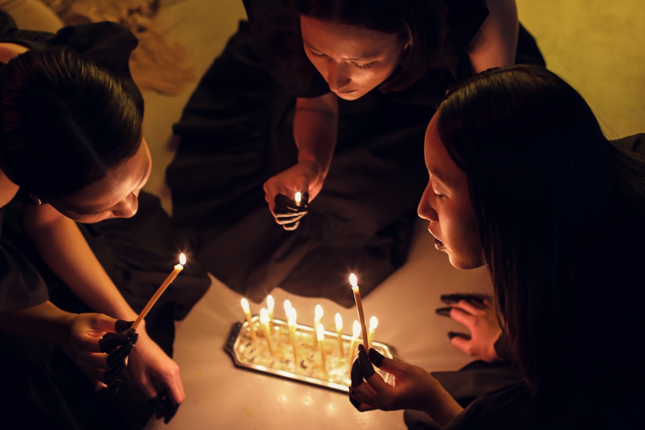 A Group Of Women Holding Lighted Candles