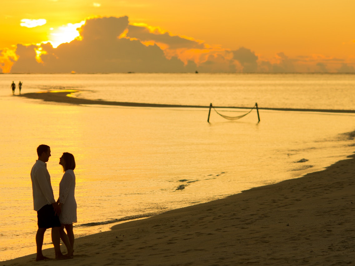 Man and Woman Facing Each Other in Front of Golden Hour