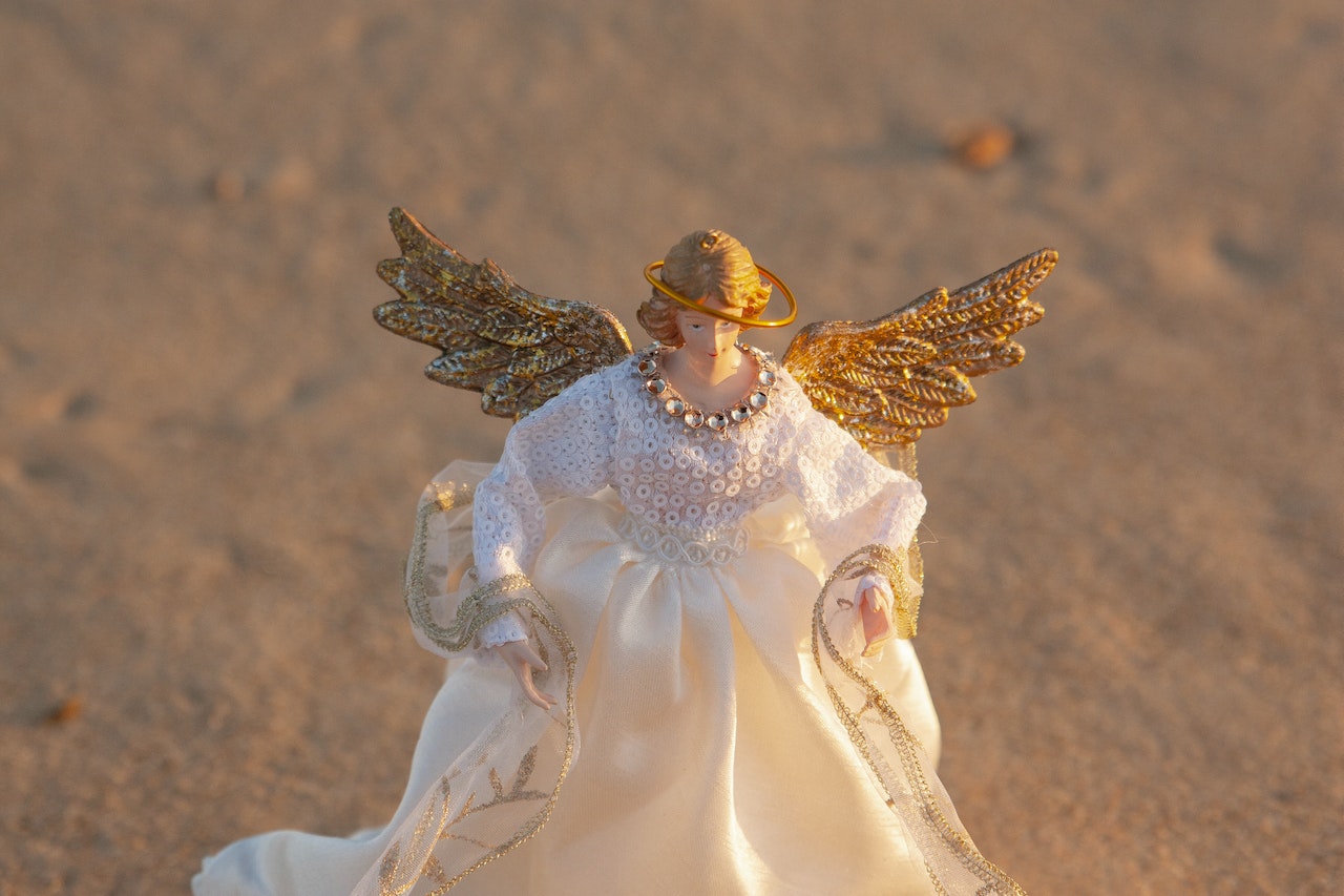 An Angel Figurine Placed On A Sand