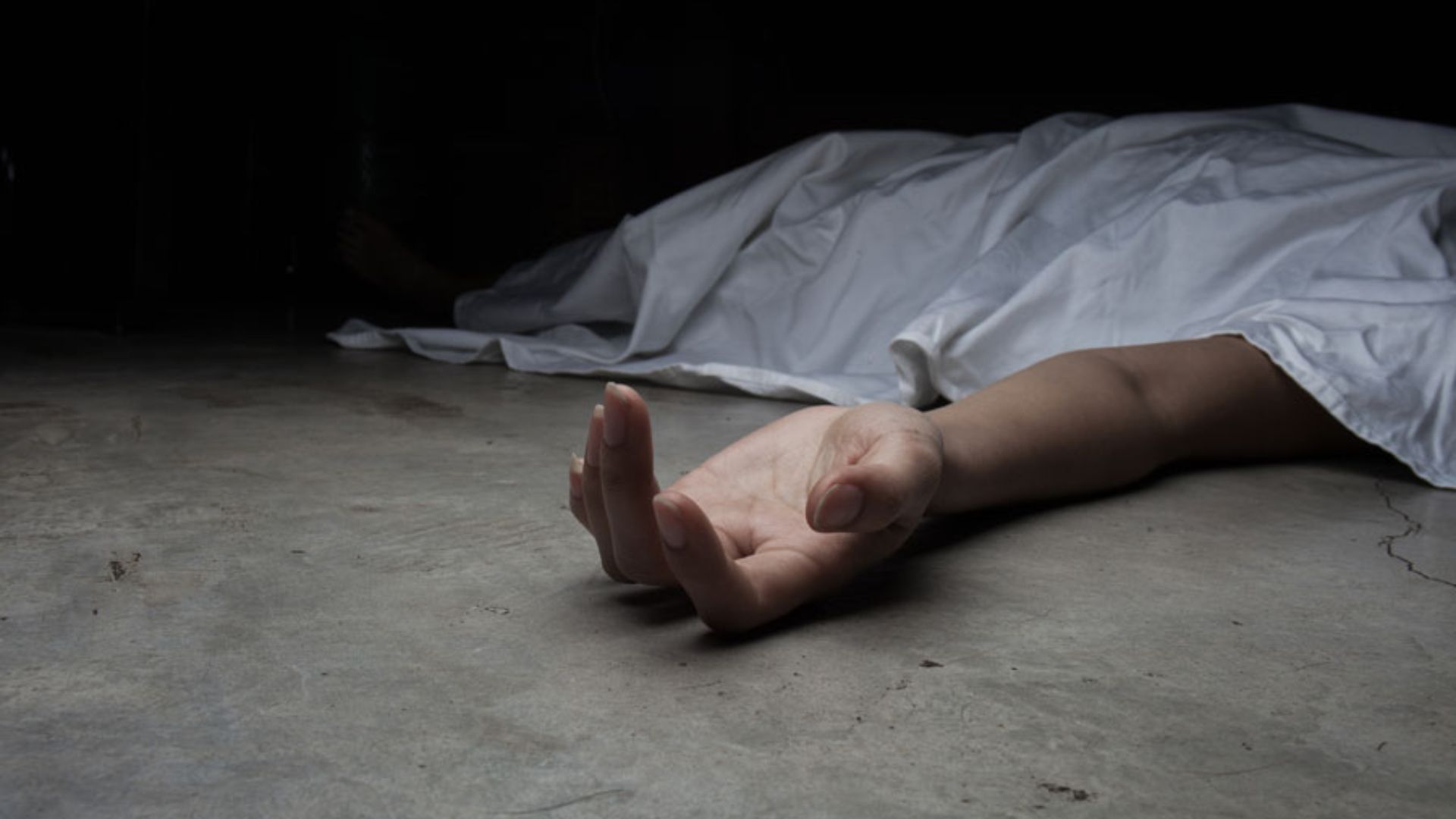 A Dead Person Lying On A Concrete Floor With An Arm Outstretched