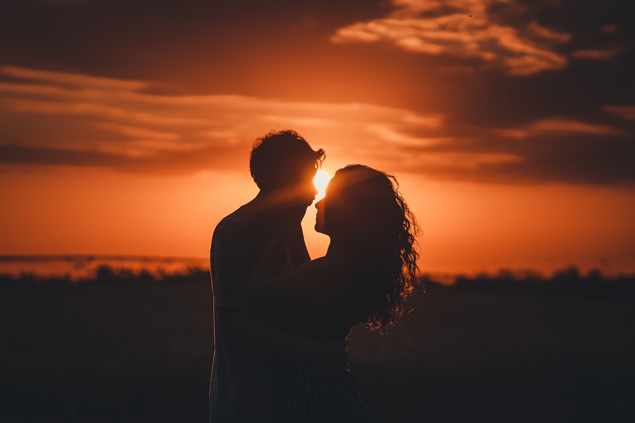 Man and Woman About to Kiss Each Other During Sunset