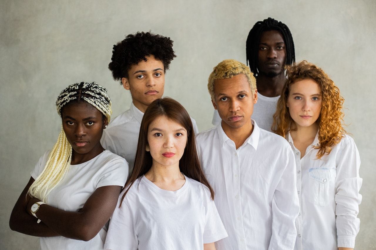 Group of diverse young people with different appearances all wearing white
