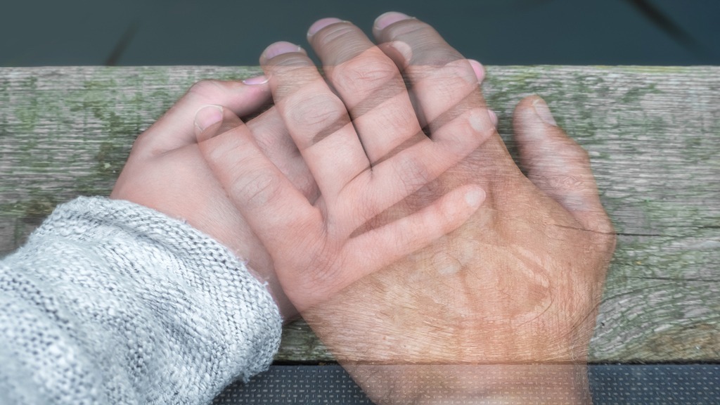 A spirit holding the hand of a person