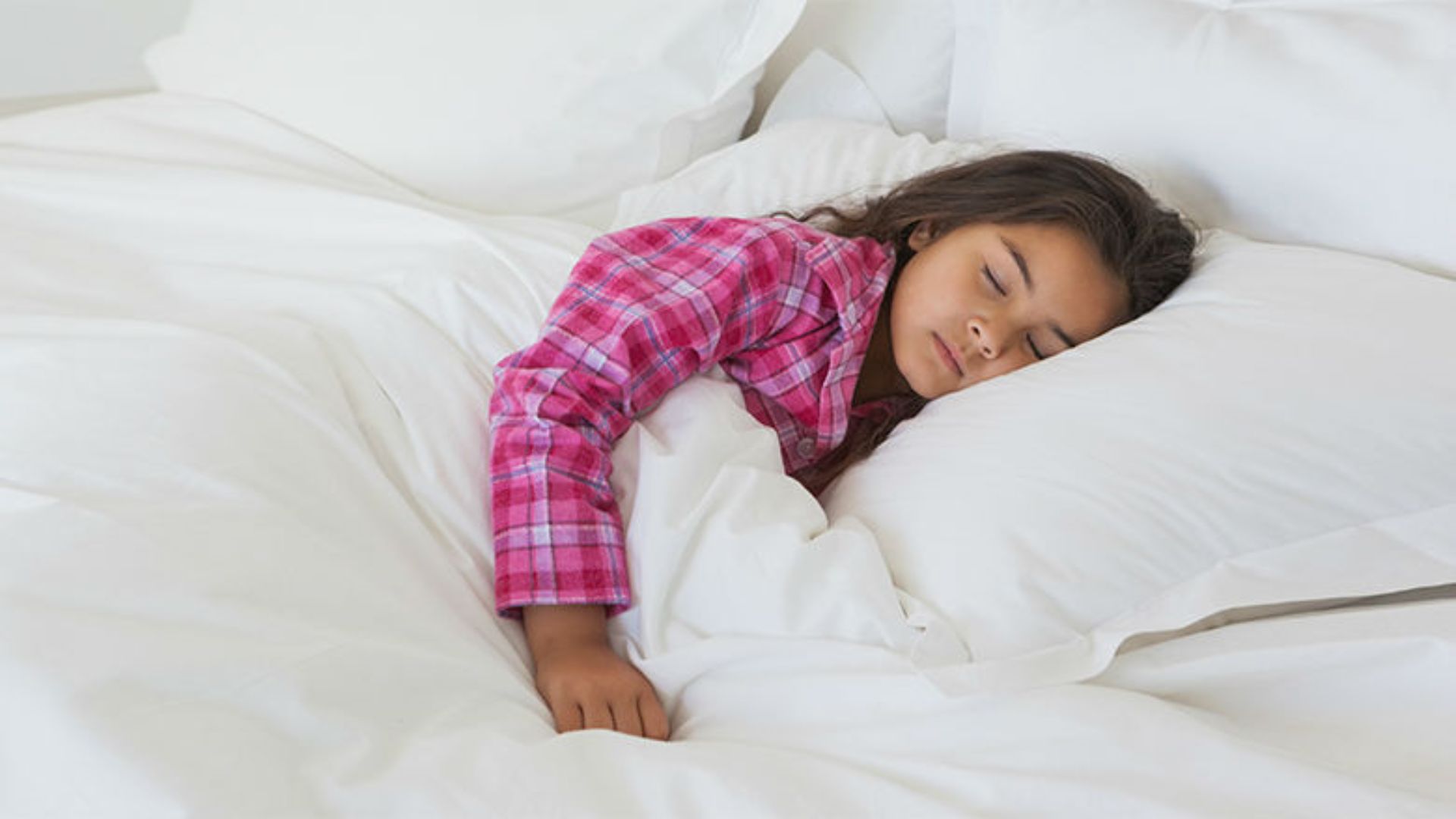 Girl In Pink Outfit Sleeping On White Bed
