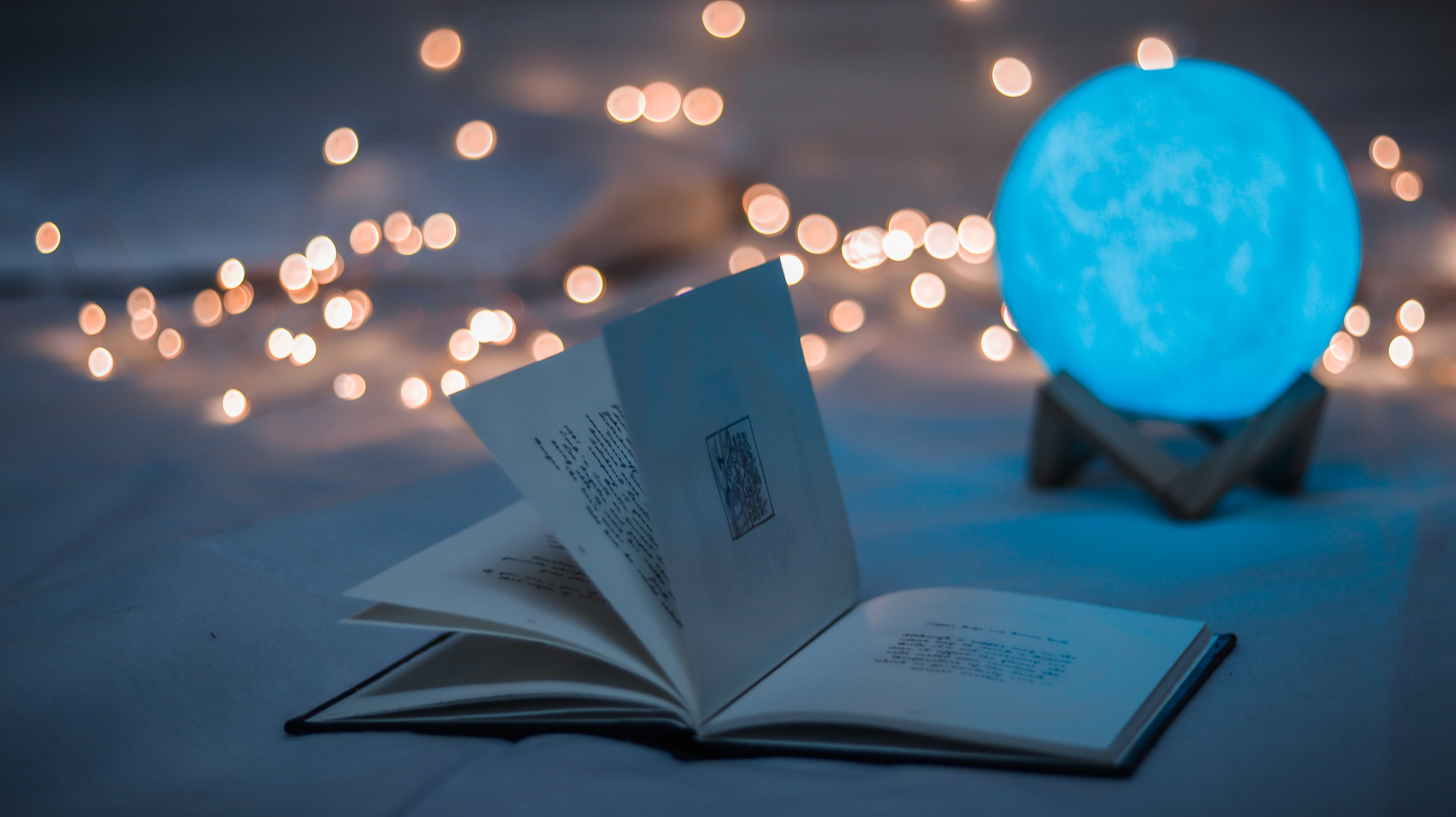 An open book and a blue crystal globe