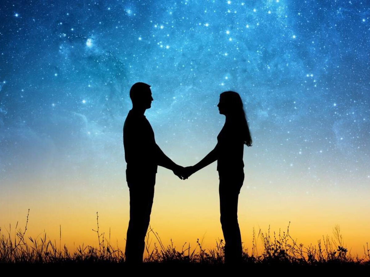 A man and woman holding hands while standing