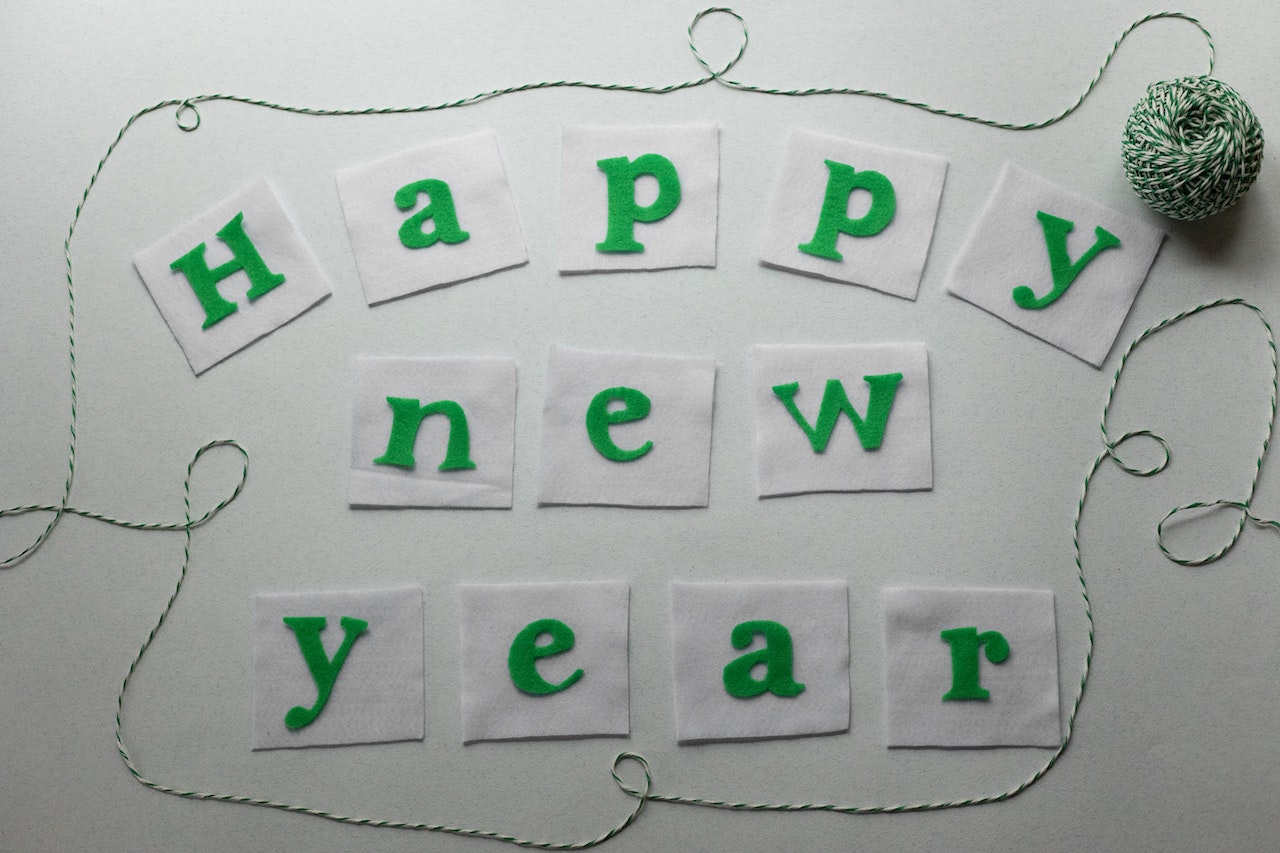 Happy New Year title on fabric squares on light background