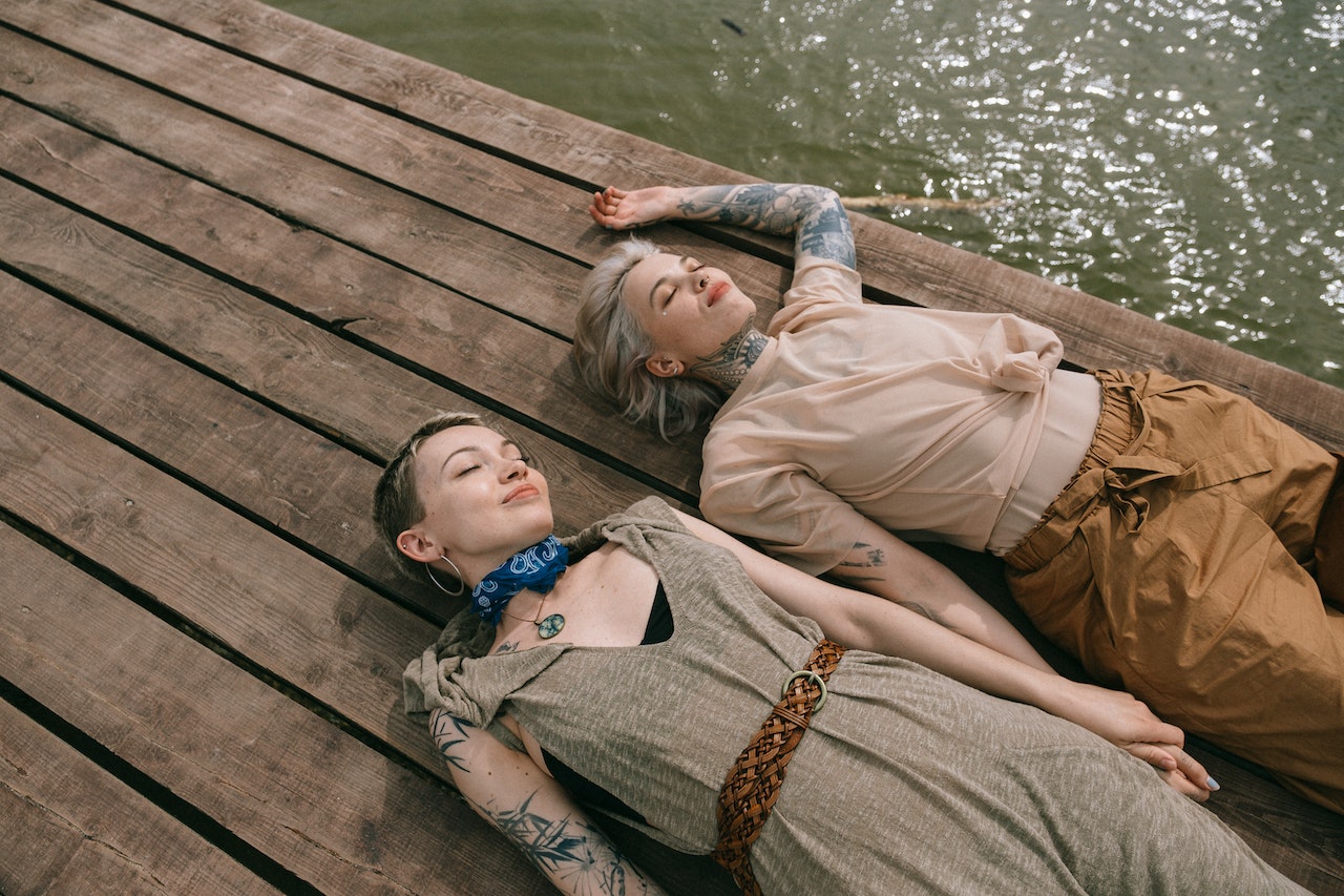 Women Lying Down on Wooden Planks