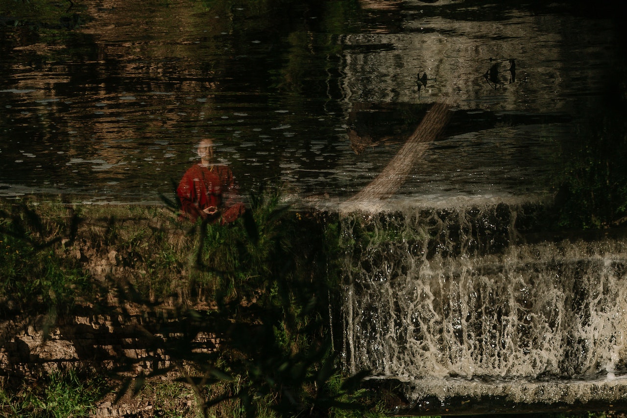 Person in Red Jacket Standing on Water